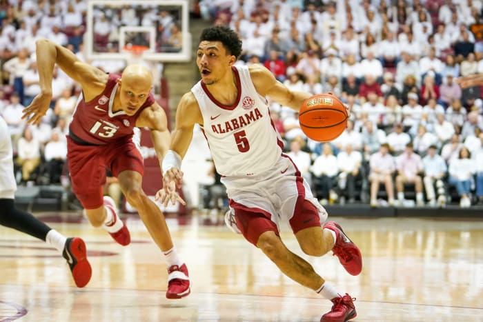 Feb 25, 2023; Tuscaloosa, Alabama, USA; Alabama Crimson Tide guard Jahvon Quinerly (5) drives to the basket against Arkansas Razorbacks guard Jordan Walsh (13) during the second half at Coleman Coliseum. Mandatory Credit: Marvin Gentry-USA TODAY Sports